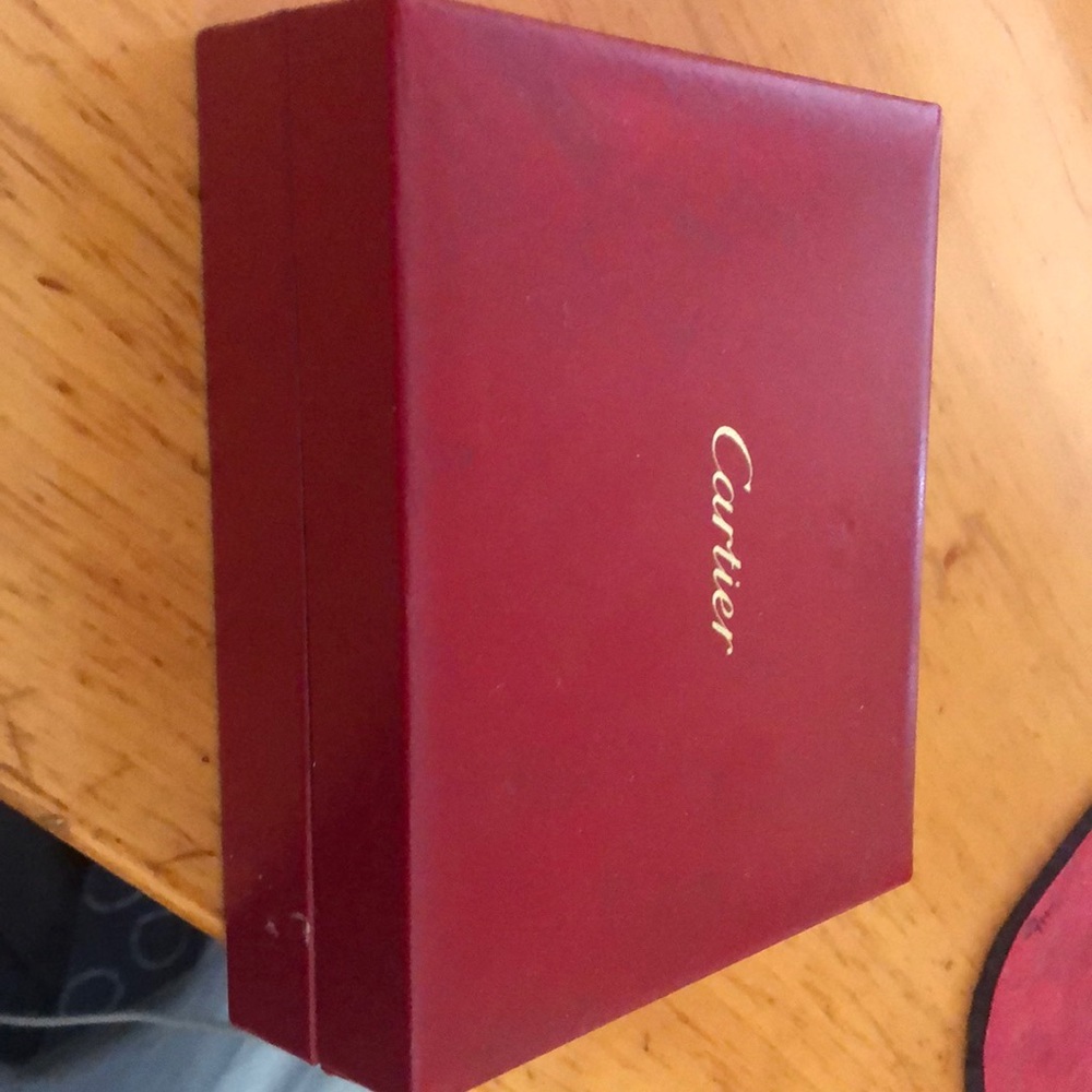 Four sterling silver salt / pepper shakers. Cartier comes with red leather case!